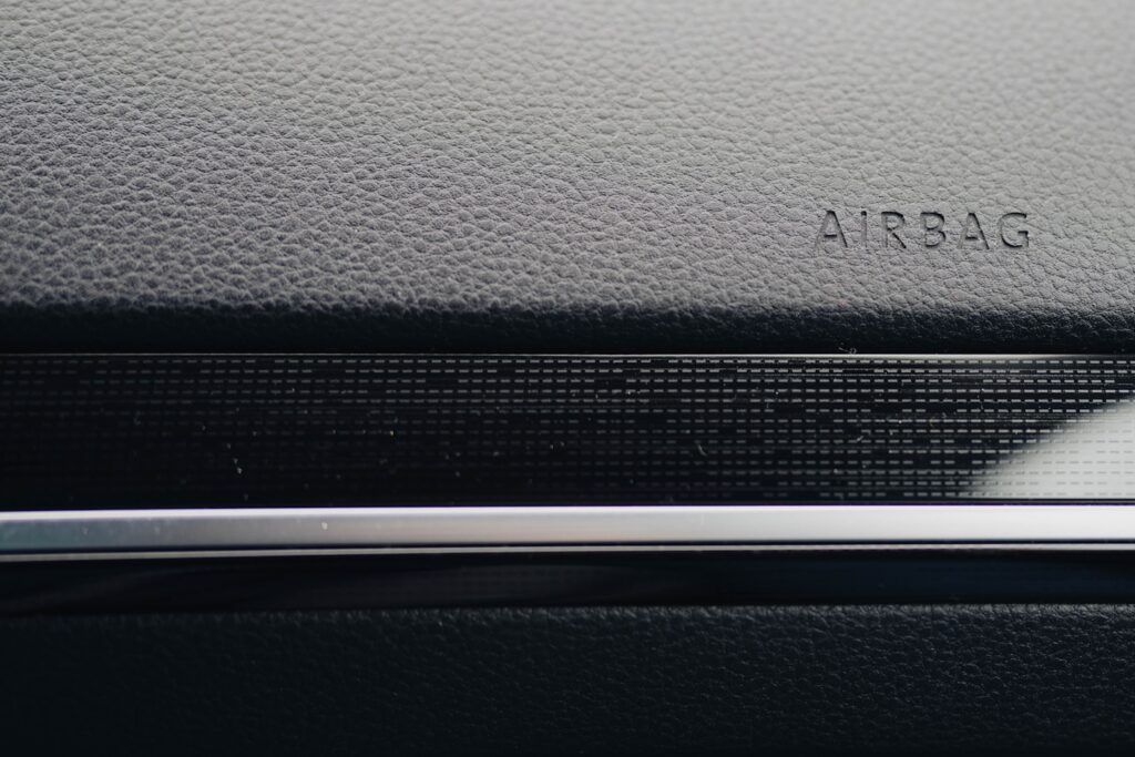 Close-up of a car's dashboard, showing "airbag."