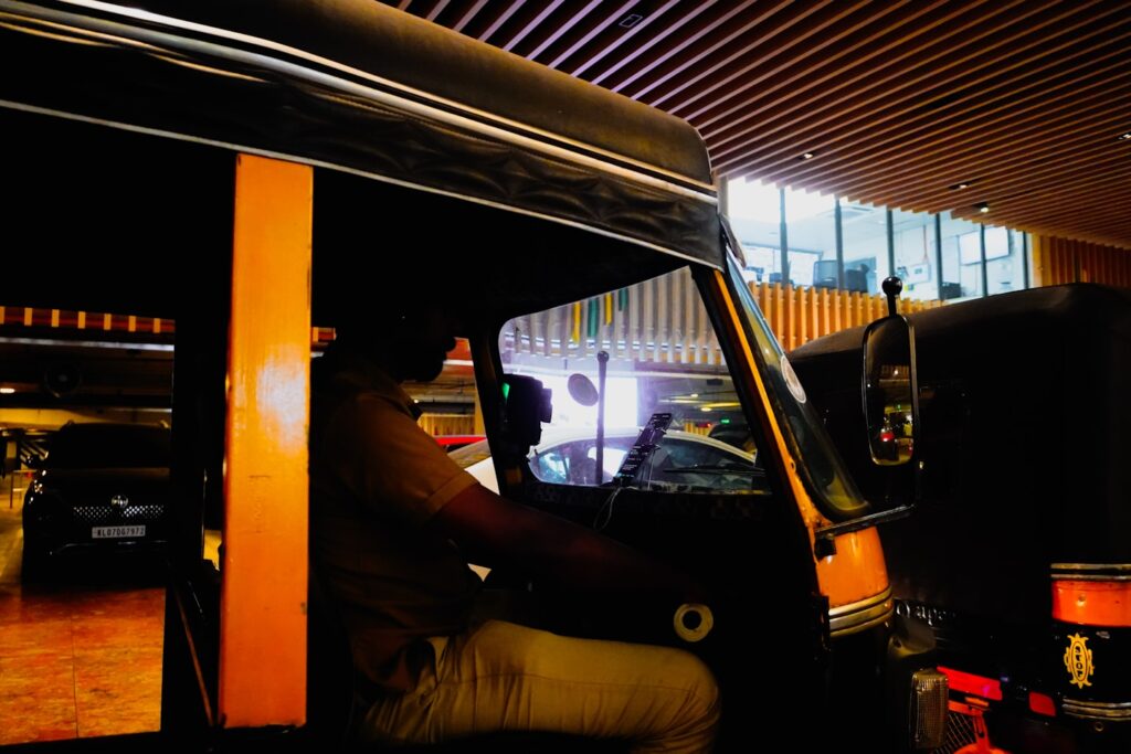Driver in auto-rickshaw inside a building