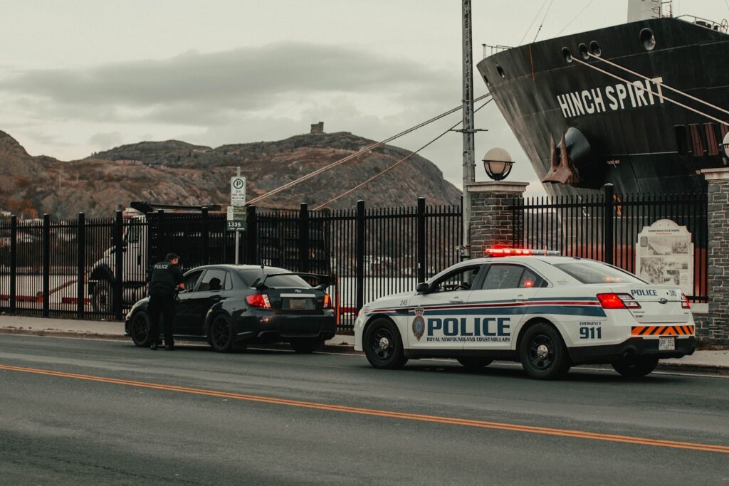 white and blue police car on road
