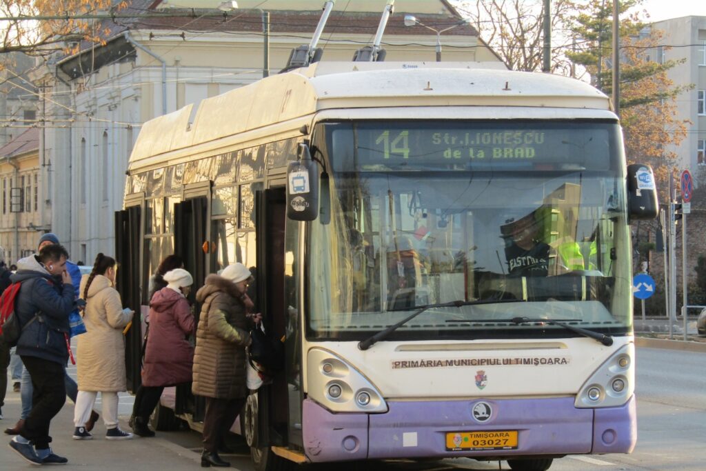 A group of people getting on a bus