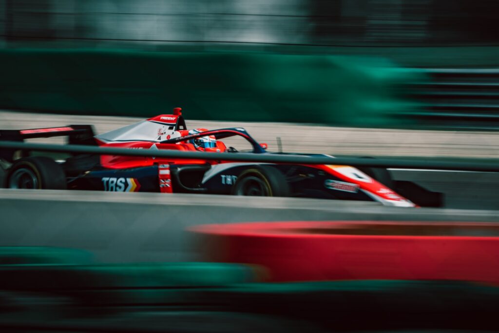 a man driving a race car on a track