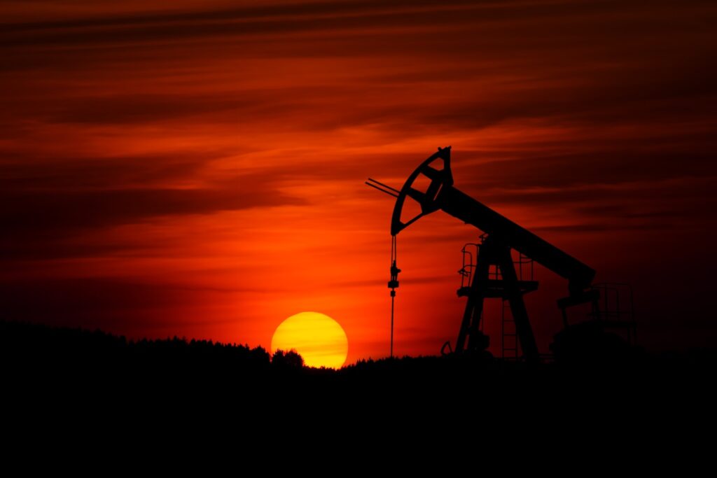 Pump-jack mining crude oil with the sunset