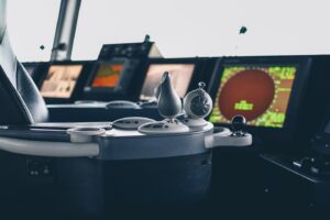 Control panel, joystick, screen and buttons of a cruise ferry in the cockpit.