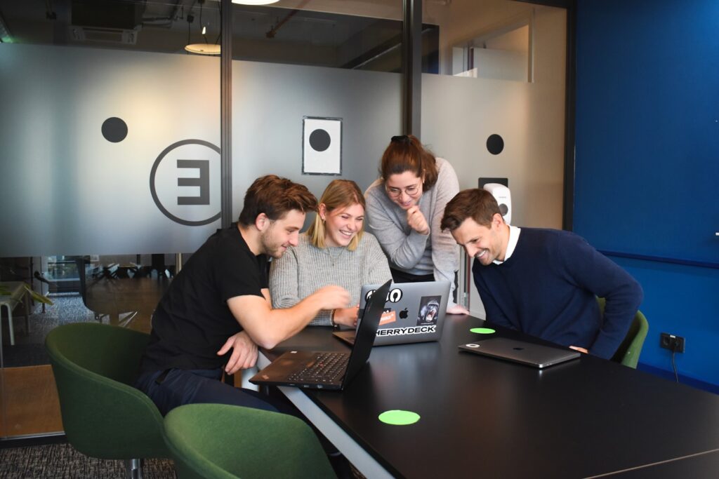 people sitting on chair in front of laptop computers