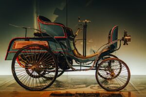 An antique car is displayed indoors.