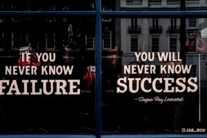 Motivational sign in the window of a boxing gym.